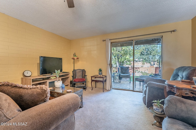 living room featuring light carpet, brick wall, and a textured ceiling