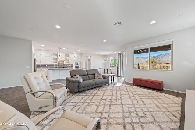 living room featuring a chandelier and hardwood / wood-style floors