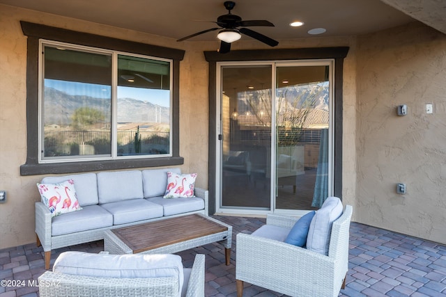 view of patio with an outdoor living space and ceiling fan