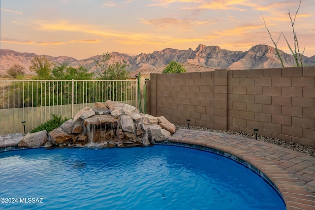 pool at dusk with a mountain view