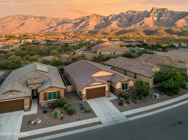 aerial view at dusk featuring a mountain view