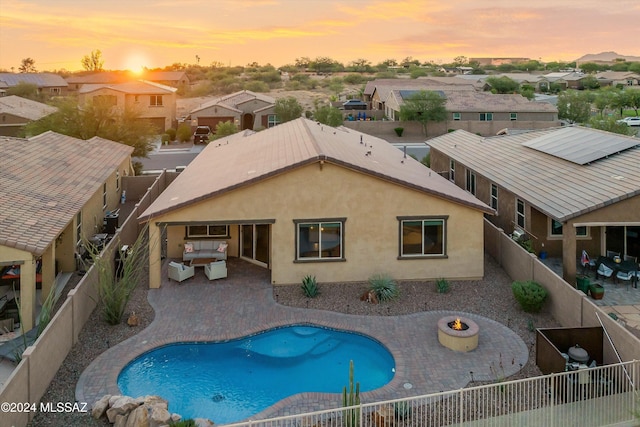 pool at dusk with a patio