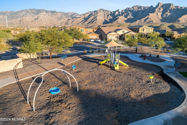 exterior space featuring a playground and a mountain view