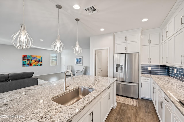 kitchen with stainless steel fridge with ice dispenser, dark hardwood / wood-style flooring, hanging light fixtures, sink, and white cabinets