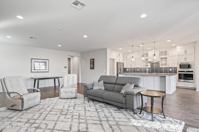 living room with sink and light hardwood / wood-style floors