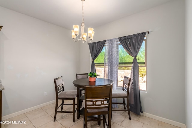 tiled dining room with a chandelier