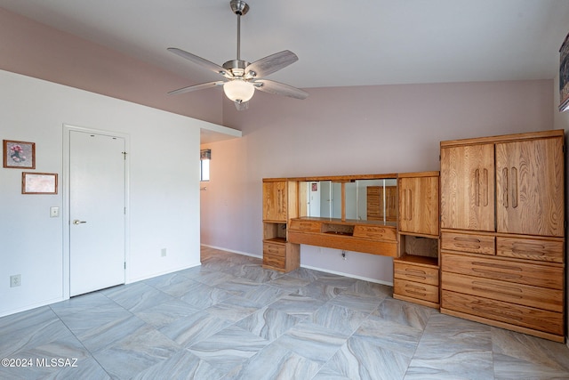 unfurnished living room with built in desk, vaulted ceiling, and ceiling fan