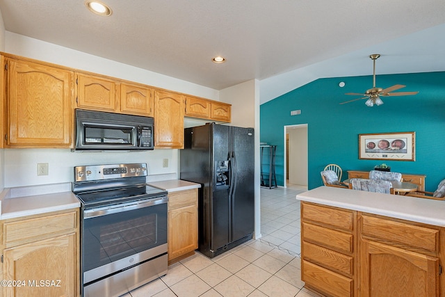 kitchen featuring light tile patterned floors, black appliances, vaulted ceiling, and ceiling fan