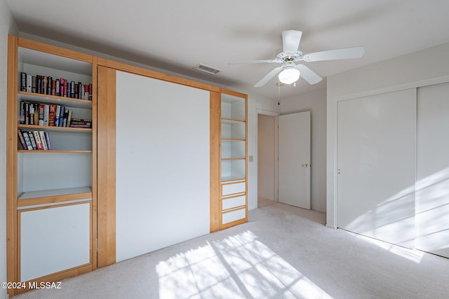 unfurnished bedroom with ceiling fan and light carpet