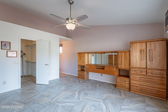 interior space with ceiling fan and vaulted ceiling