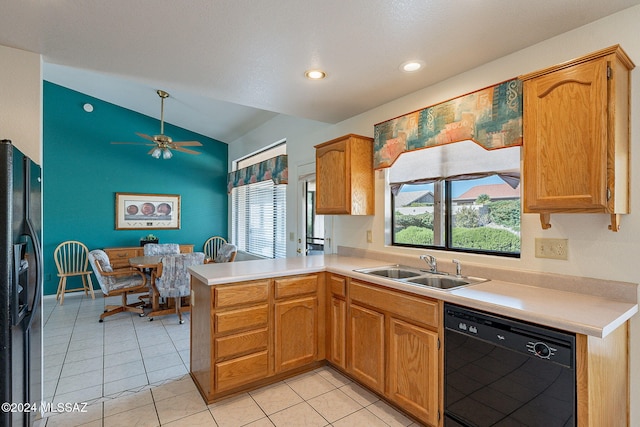 kitchen with black appliances, light tile patterned flooring, sink, kitchen peninsula, and vaulted ceiling