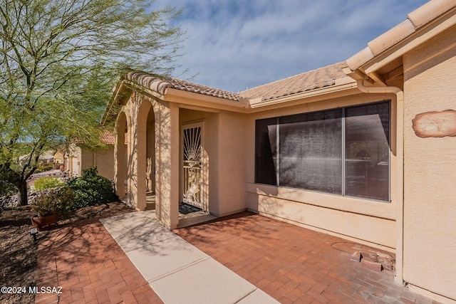 entrance to property featuring a patio