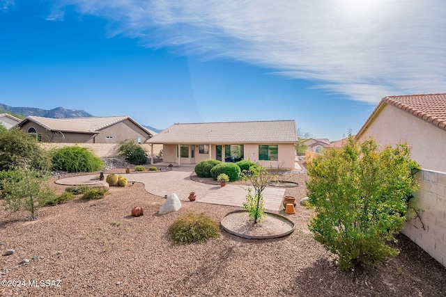 rear view of house featuring a patio and a mountain view