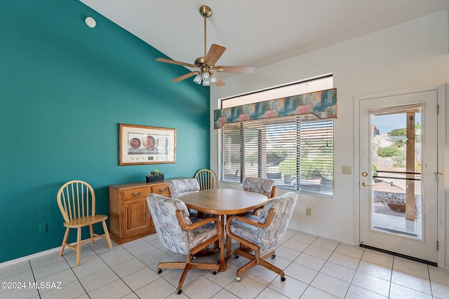 dining space featuring vaulted ceiling, light tile patterned flooring, and ceiling fan