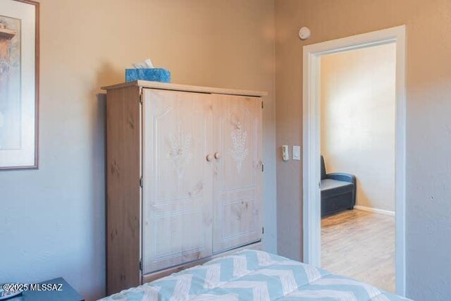 2112 E 18th St, Tucson, AZ 85719 - unfurnished bedroom with light hardwood / wood-style flooring and a closet