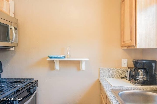 2112 E 18th St, Tucson, AZ 85719 - kitchen featuring light brown cabinets and appliances with stainless steel finishes