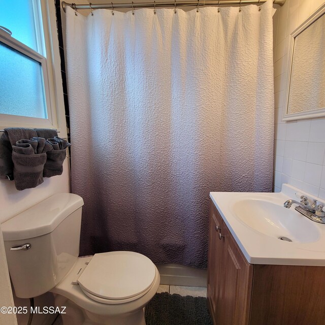 2112 E 18th St, Tucson, AZ 85719 - full bathroom with vanity, shower / bath combination with curtain, tile patterned flooring, toilet, and tile walls