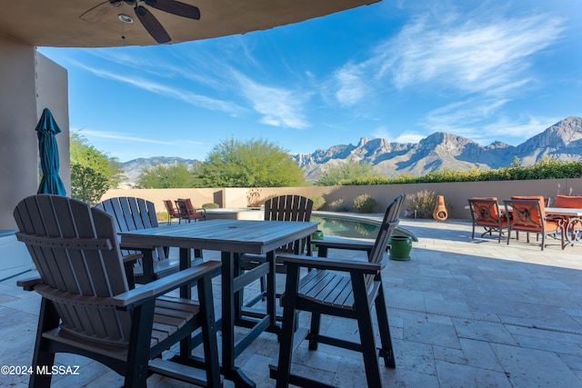 view of patio with a mountain view and ceiling fan