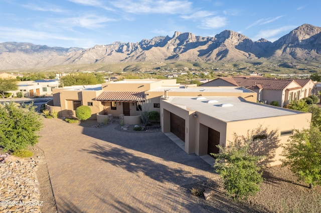 view of front of home featuring a mountain view and a garage