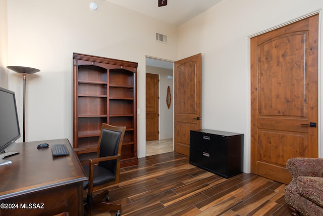 office area with ceiling fan, dark hardwood / wood-style flooring, and a high ceiling