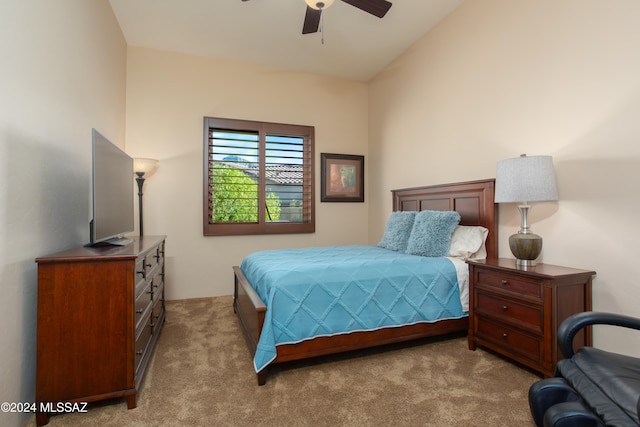 bedroom featuring ceiling fan, lofted ceiling, and light carpet