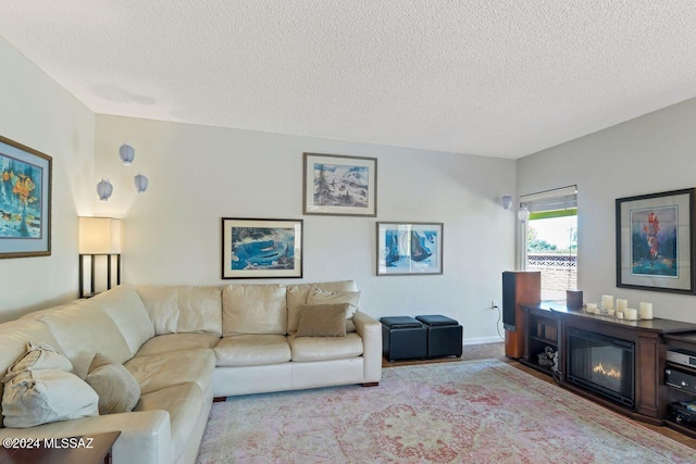 living room featuring a textured ceiling and light carpet