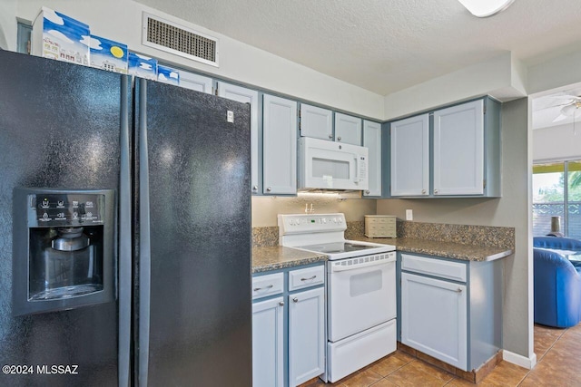 kitchen featuring white appliances, ceiling fan, a textured ceiling, and light tile patterned flooring