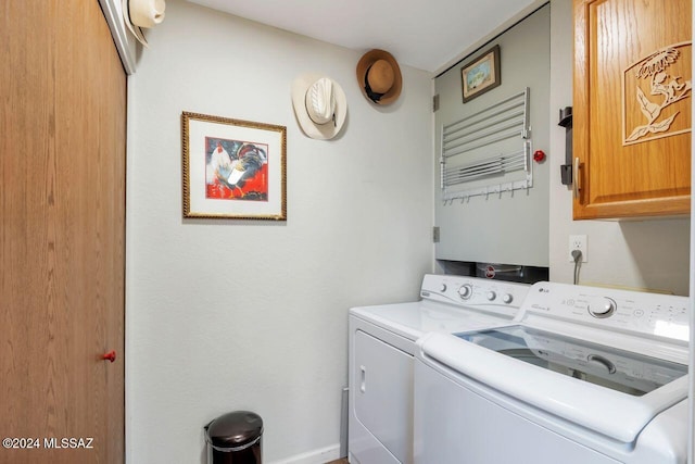 laundry room with cabinets and washing machine and clothes dryer