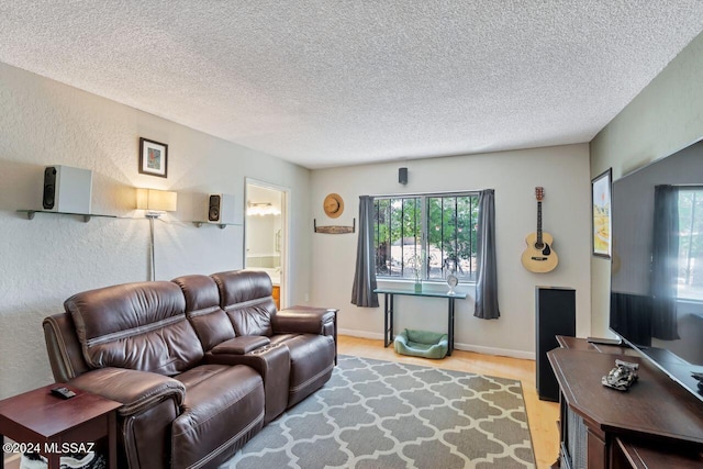 living room featuring a textured ceiling and light hardwood / wood-style floors