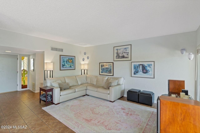 tiled living room with a textured ceiling