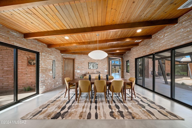 unfurnished dining area with finished concrete flooring, brick wall, beam ceiling, and visible vents