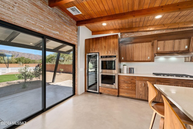 kitchen with stainless steel appliances, brown cabinets, light countertops, and visible vents