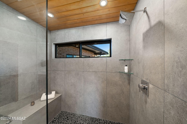 bathroom with recessed lighting, wood ceiling, and tiled shower