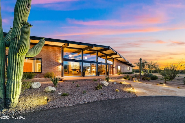 view of back of house at dusk