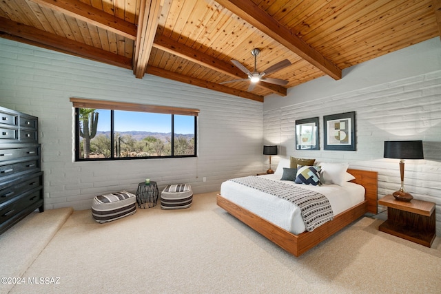 carpeted bedroom featuring vaulted ceiling with beams, a mountain view, wood ceiling, and a ceiling fan