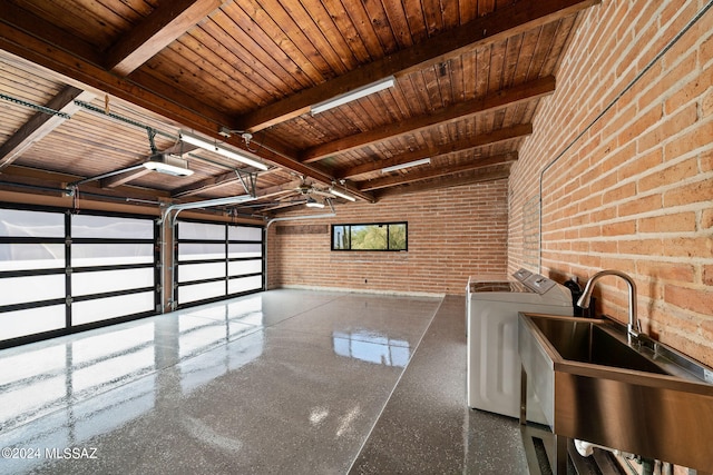 garage with washer and clothes dryer, wood ceiling, sink, and a garage door opener