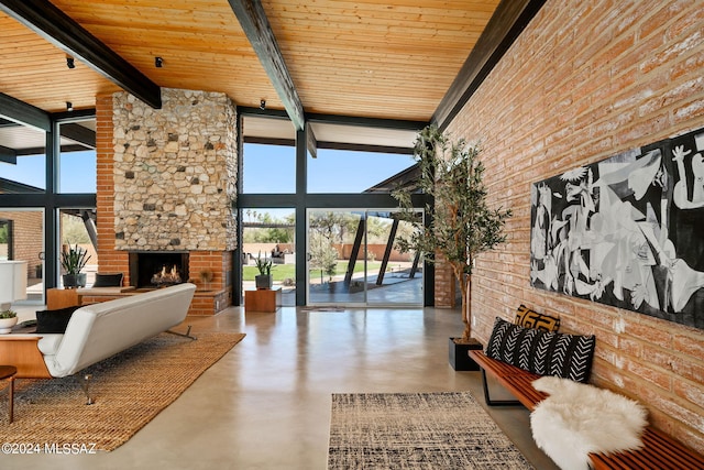 living room featuring beamed ceiling, expansive windows, and a healthy amount of sunlight