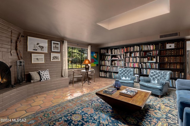 living room featuring a brick fireplace