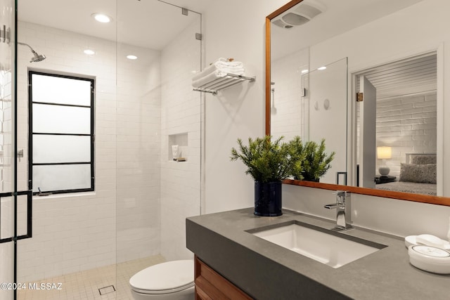 bathroom featuring walk in shower, vanity, and toilet