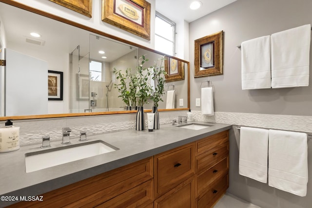 bathroom featuring vanity and an enclosed shower