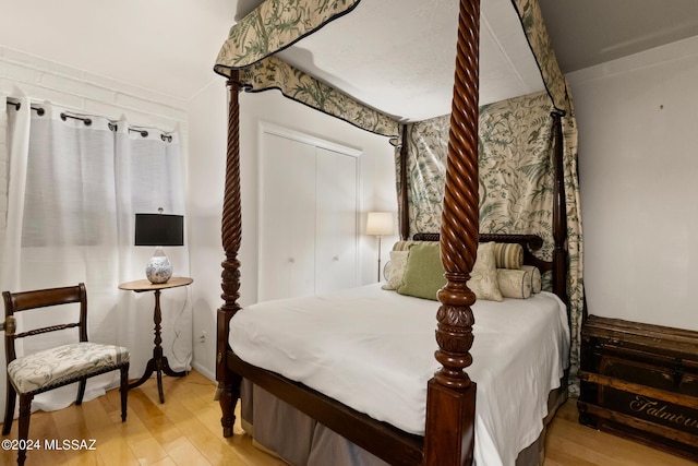 bedroom with a closet and hardwood / wood-style floors