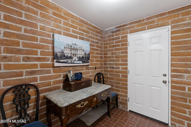 dining area featuring brick wall