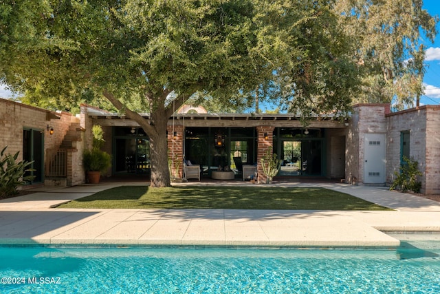 back of house with a patio