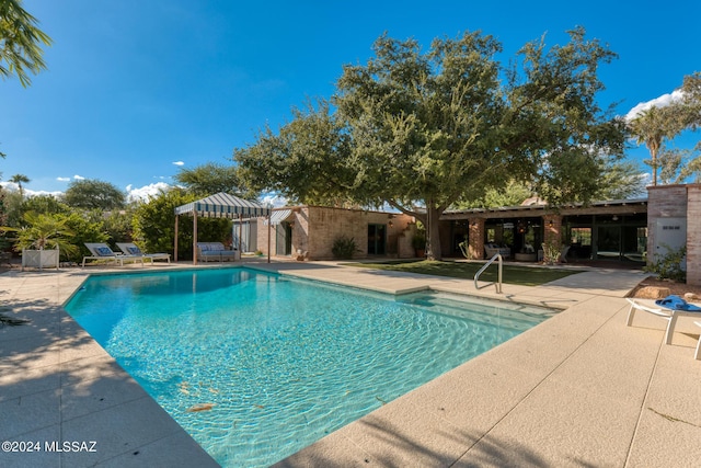 view of pool featuring a patio area