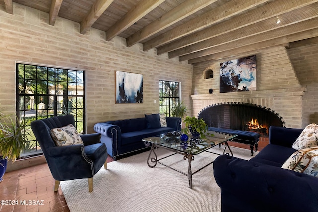 living room with beamed ceiling, wood ceiling, and a fireplace