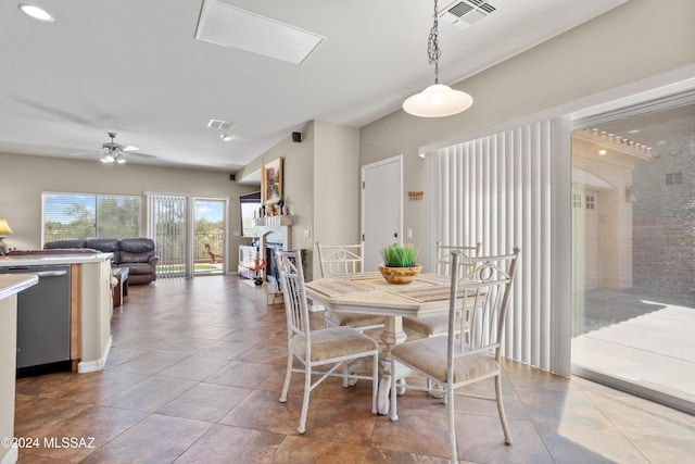 dining area featuring visible vents, ceiling fan, and a fireplace