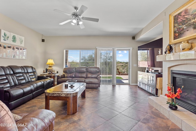 living room featuring ceiling fan and a fireplace