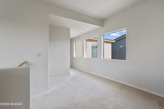 unfurnished room featuring light colored carpet