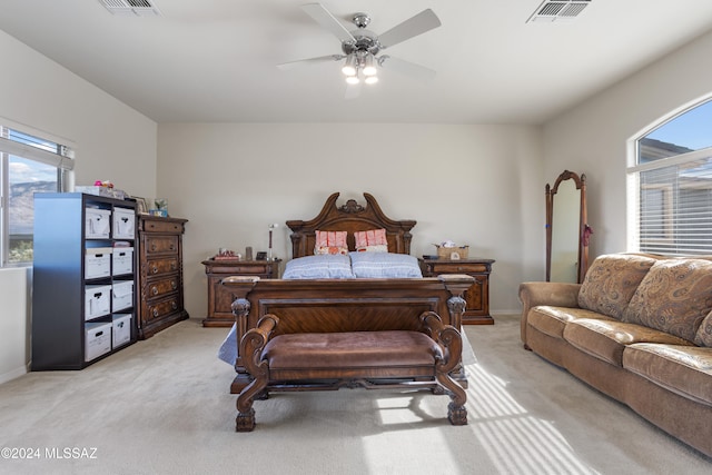 carpeted bedroom with ceiling fan and multiple windows