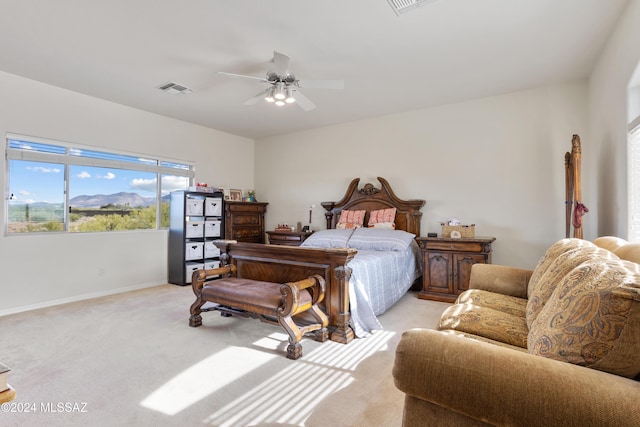 bedroom with ceiling fan, baseboards, visible vents, and light carpet